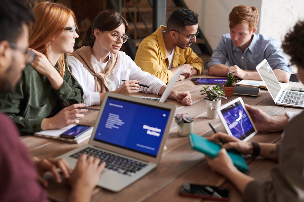 A diverse group of professionals having a collaborative meeting in a modern office setting.